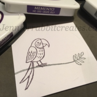 Step 2: I stamped the left Parrot in my chosen Memento Elderberry ink.